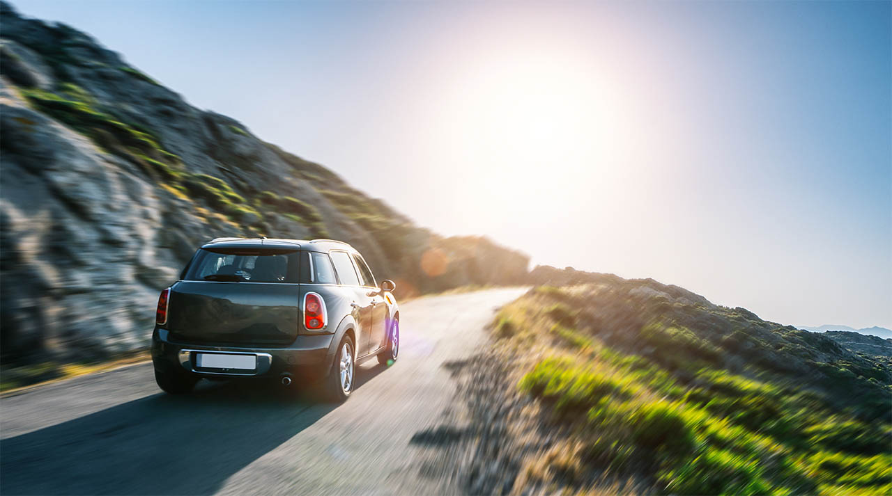 car in mountain landscape road at sunset IDP